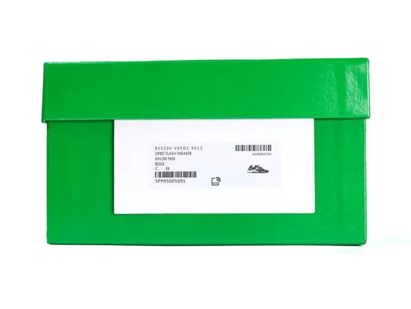 Green cardboard shoe box with a white label, barcode, and printed sneaker illustration.