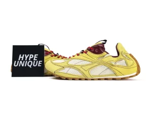 Yellow suede sneakers with mesh panels, maroon accents, and gum sole.
