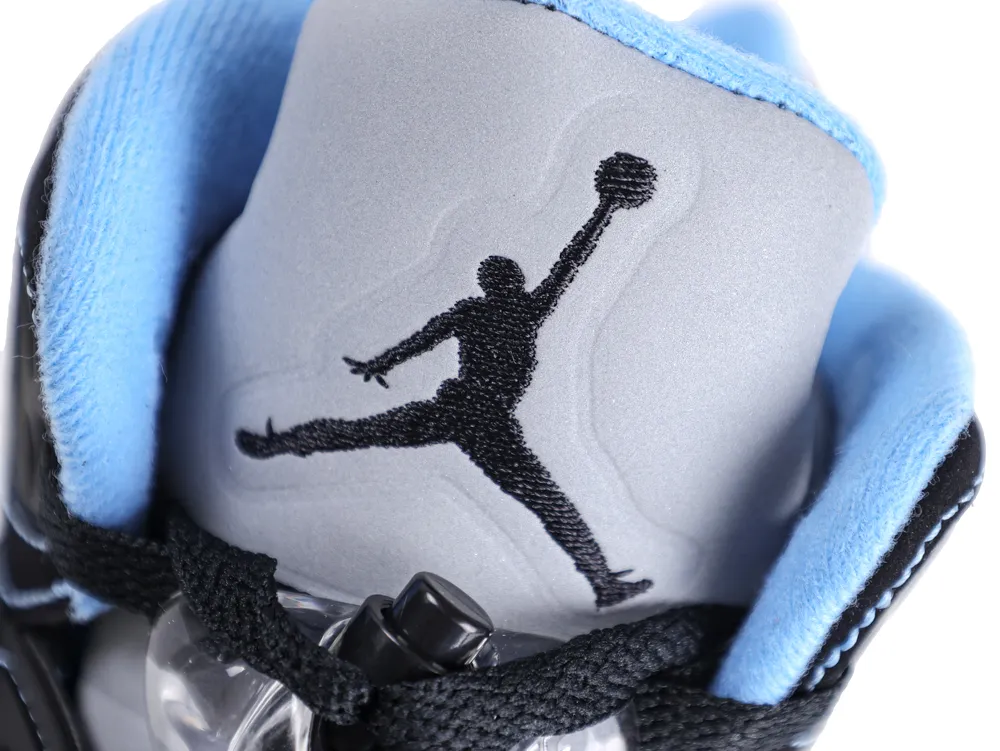 Gray and blue fabric sneaker tongue with black embroidered logo design.