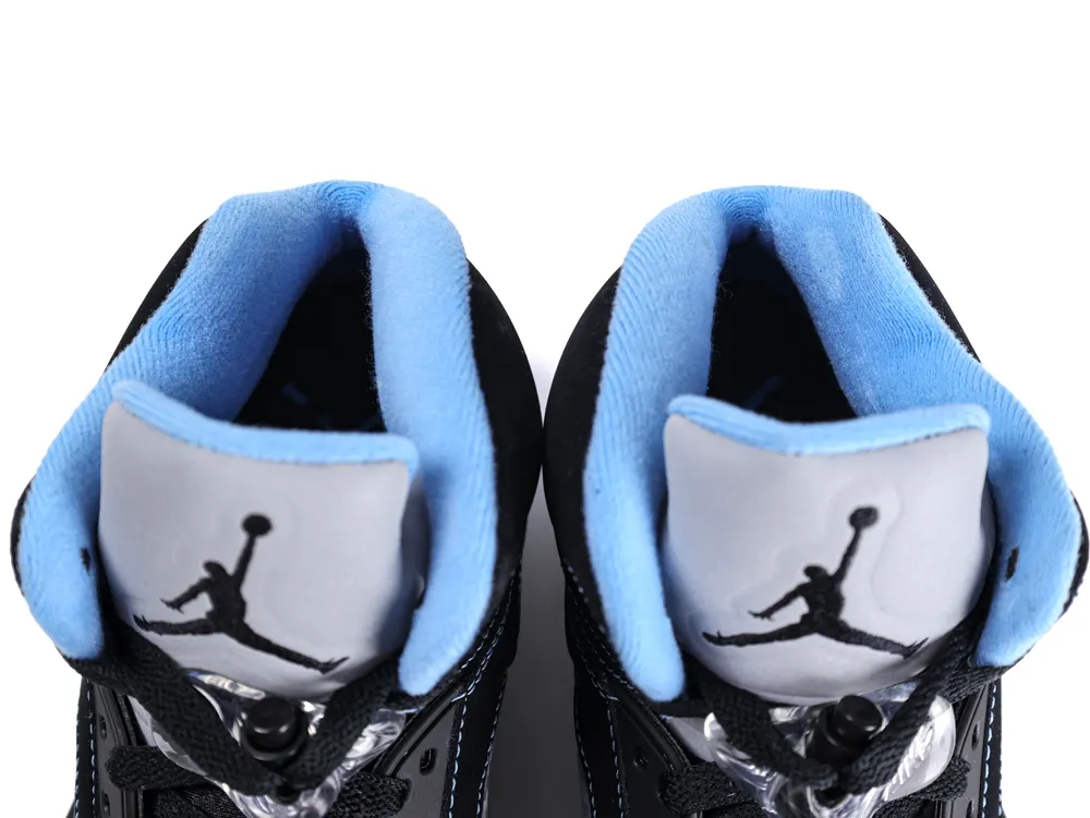 Black sneakers with light blue lining and gray tongue featuring a logo.
