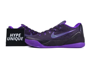 Purple and black sneakers with mesh material, featuring signature and brand logo details.