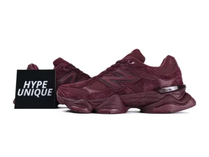 Burgundy suede sneakers with rubber soles and leather accents, side profile view.