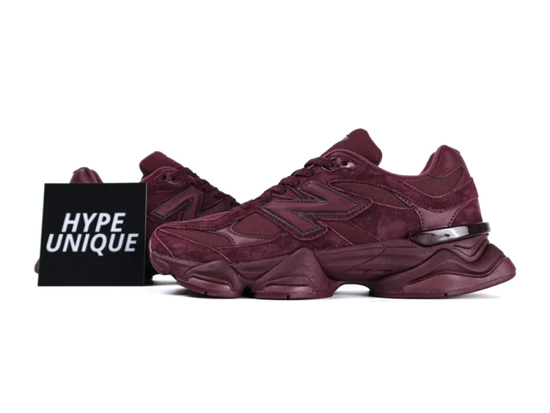 Burgundy suede sneakers with rubber soles and leather accents, side profile view.