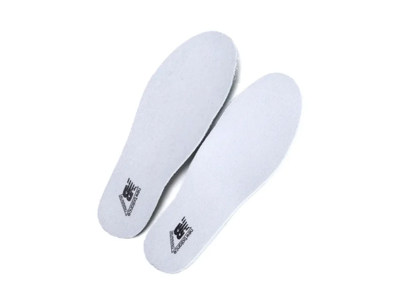 Gray foam insoles with printed logo, designed for comfort and support.