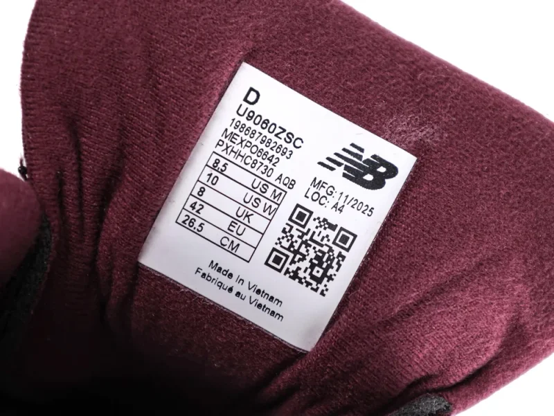 Burgundy fabric shoe tongue with white label showing size and manufacturer details.