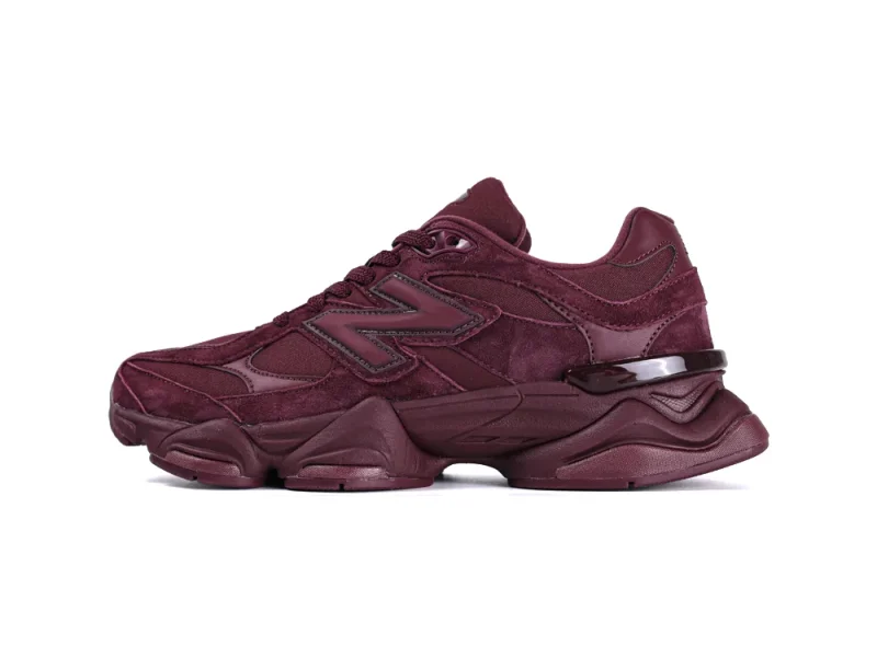 Burgundy suede sneaker with leather accents and rubber sole, side view.