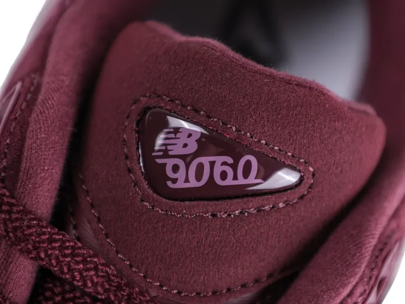 Burgundy suede shoe tongue with glossy logo detail, featuring "NB 9060".