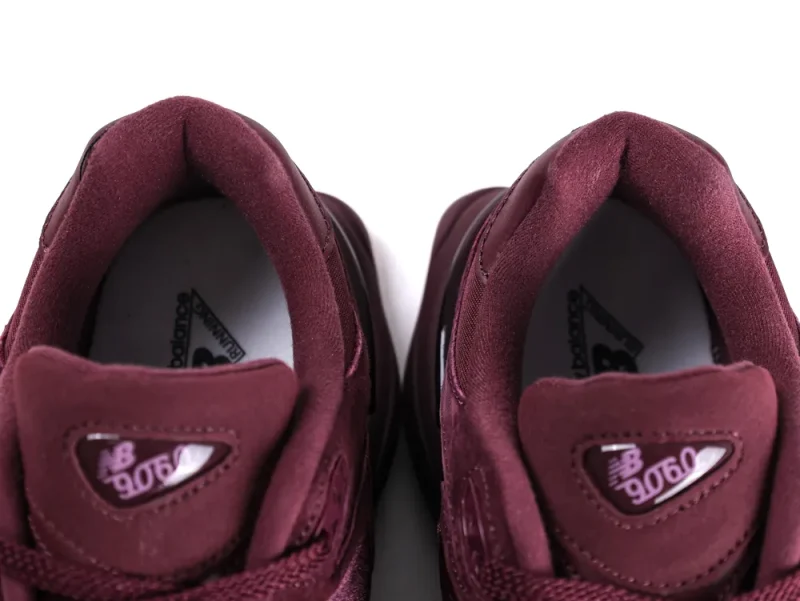 Burgundy sneakers with suede material, showcasing the tongue and inner lining details.