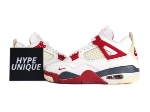 White and red leather sneakers with mesh paneling and rubber sole.