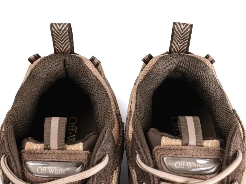Close-up of brown sneakers with fabric lining and pull tabs.