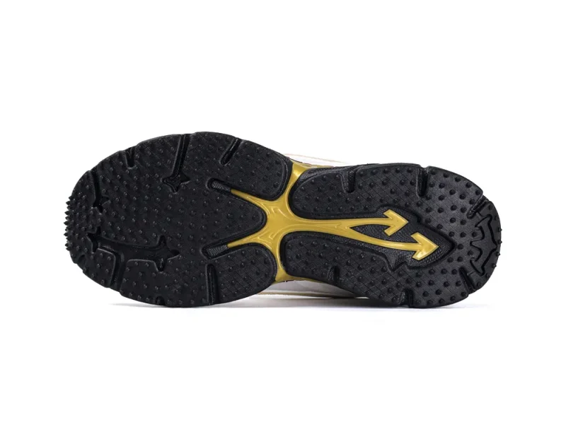 Black rubber shoe sole with gold detailing, featuring textured grip patterns.