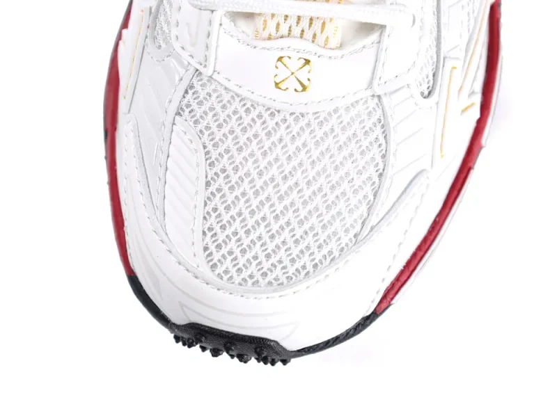White sneaker toe with mesh material, red accents, and black sole detailing.