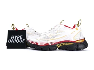 White and red sneakers with mesh and leather uppers, black and yellow soles.