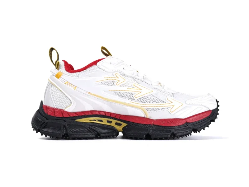 White sneaker with red and black rubber sole, yellow accents, and mesh panels.