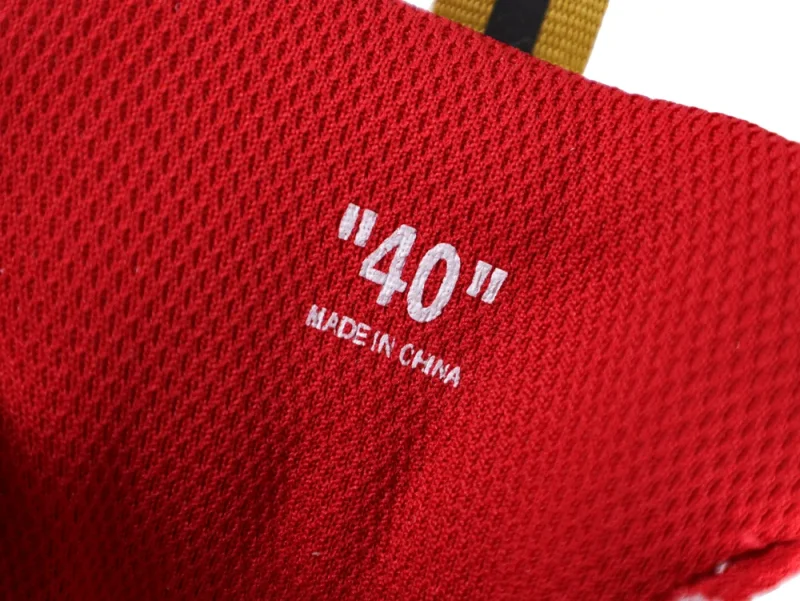 Red fabric material with white text, providing comfort and support for footwear.