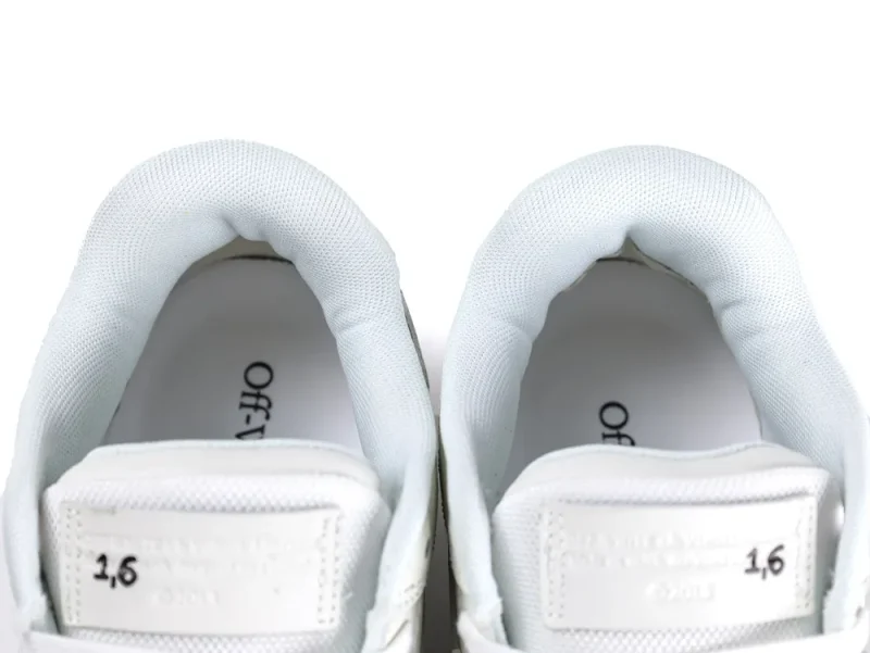 White mesh sneaker tongues with printed text and cushioned collars visible inside.