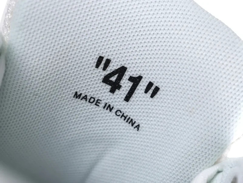 Close-up of white fabric shoe interior with size "41" and "MADE IN CHINA".
