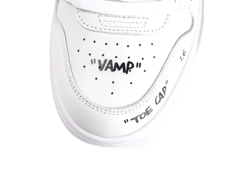 White leather sneaker showing toe cap and vamp details with black text.