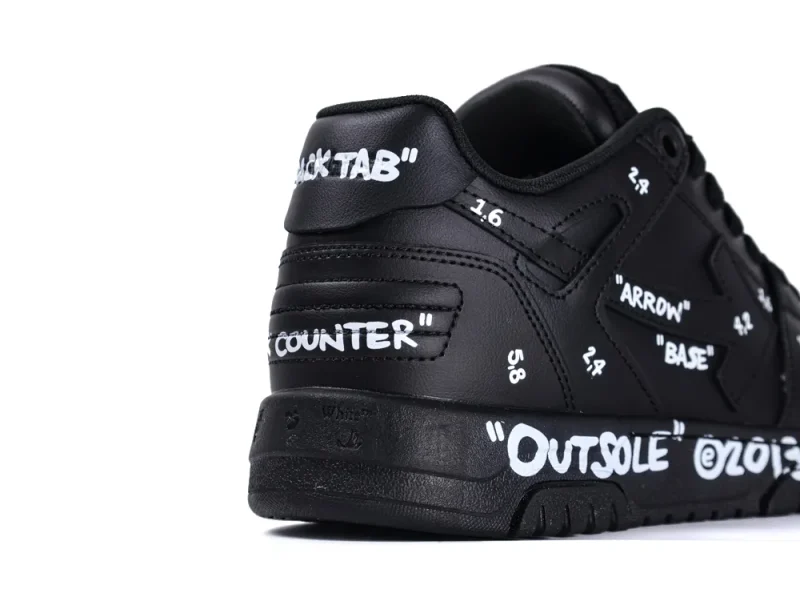 Black leather sneaker with white text accents on the heel and sides.
