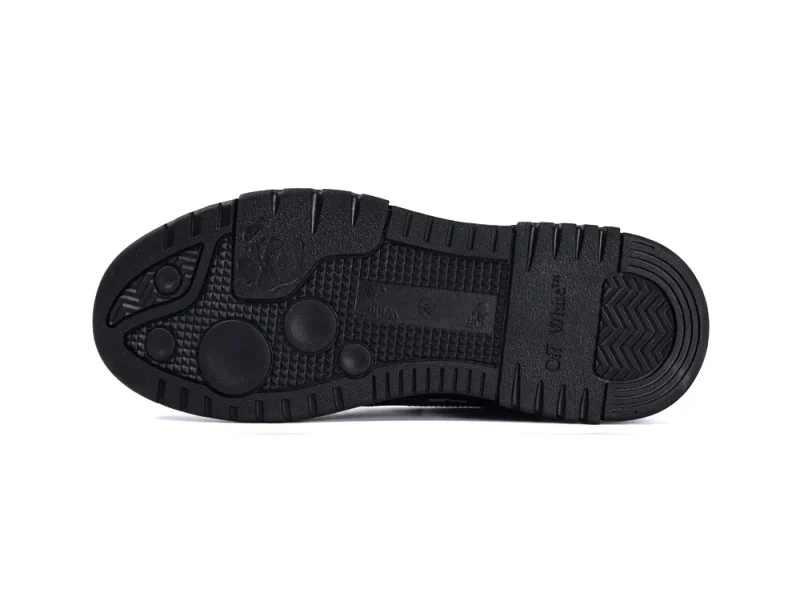 Black rubber shoe sole featuring textured grip patterns and branding details.