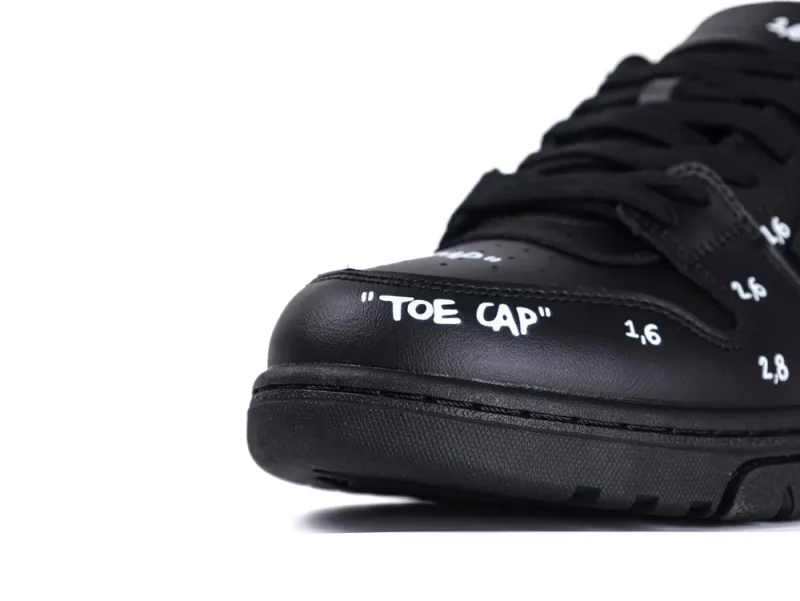 Black leather shoe with "TOE CAP" text, featuring a detailed toe design.