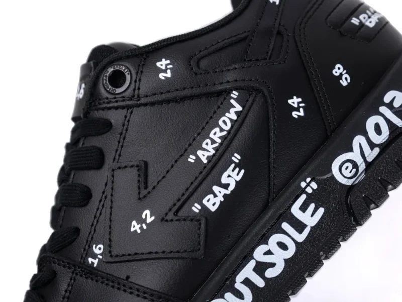 Black leather sneaker with white text details on sides and sole.