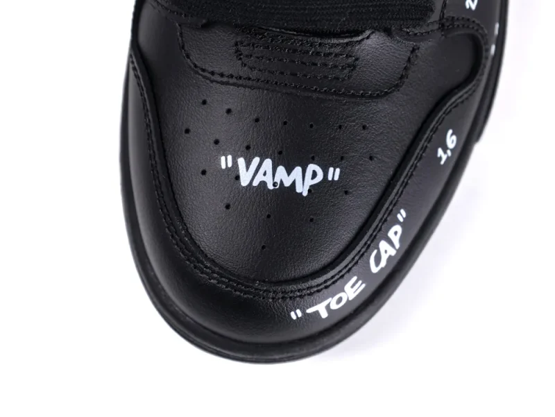 Black leather shoe vamp and toe cap with white text detailing.