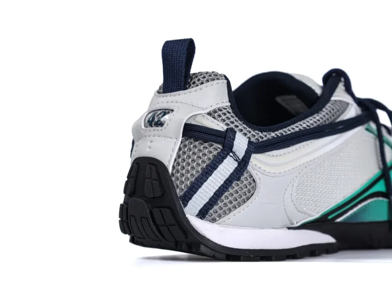 Close-up of the heel and side profile of a Balenciaga Radar Sneaker, highlighting grey mesh panels and navy pull tab.