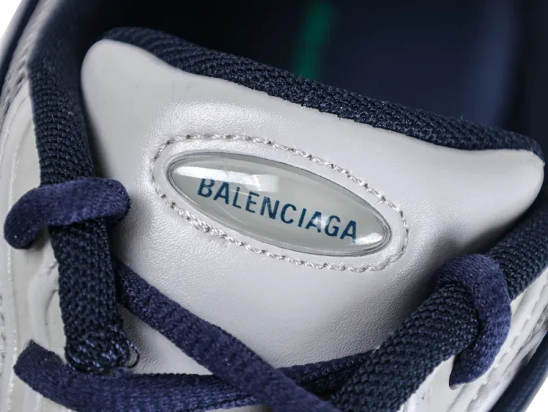 Close-up of the sneaker tongue featuring the "Balenciaga" logo under a clear oval gel overlay.
