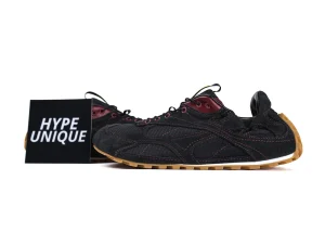 Black denim sneakers with burgundy accents and gum sole, featuring detailed stitching.
