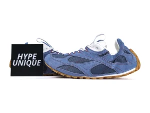 Blue and white denim sneakers with suede accents and gum rubber sole.