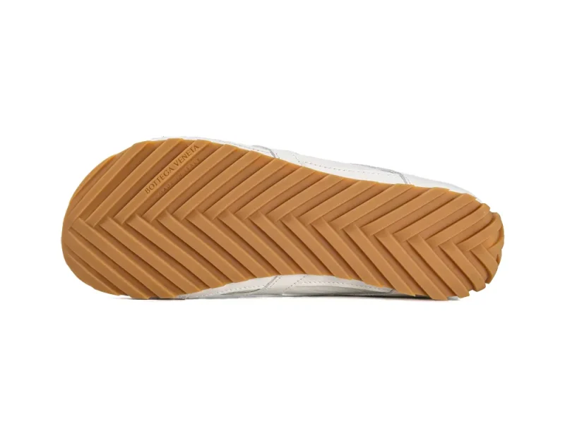 Full view of the gum rubber outsole featuring a chevron traction pattern and Bottega Veneta branding.