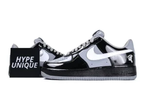 Side profile of the Nike Air Force 1 Low x Central Cee featuring black and smoke grey patent leather.