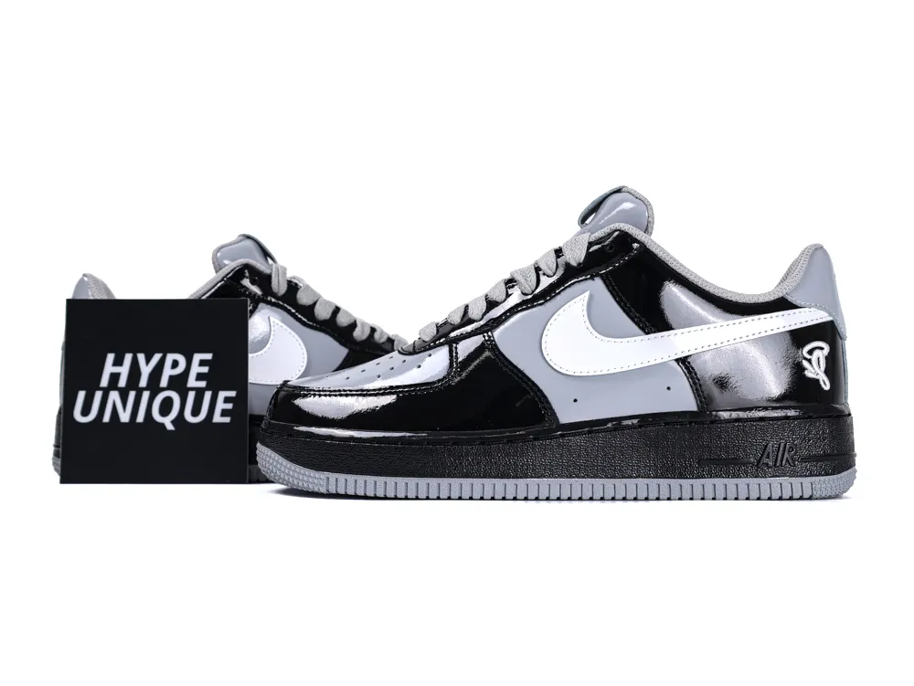 Side profile of the Nike Air Force 1 Low x Central Cee featuring black and smoke grey patent leather.