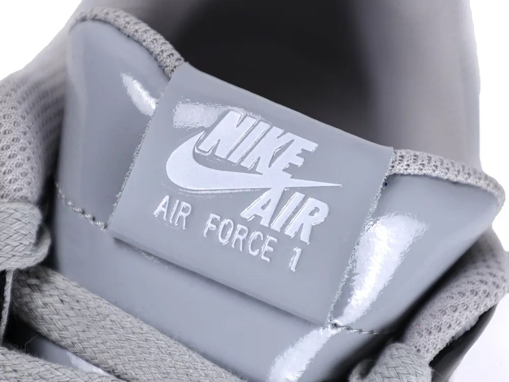 Detailed view of the smoke grey tongue tag with white Nike Air Force 1 branding.