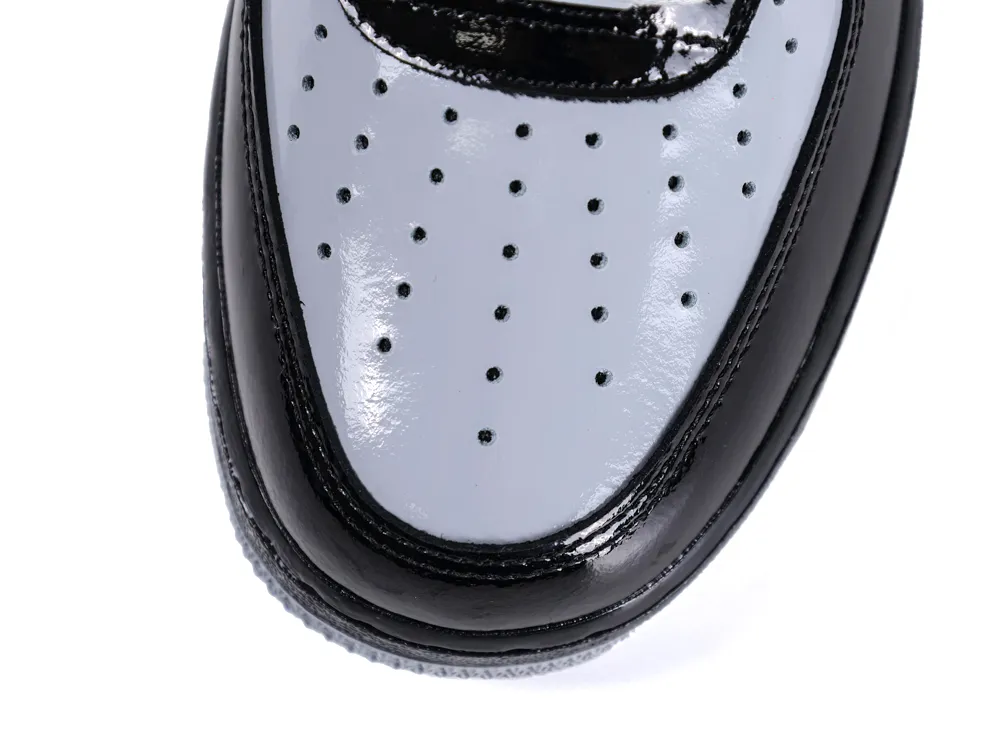 Overhead shot of the smoke grey perforated toe box and glossy black leather surround.