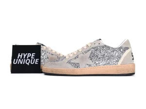 Side profile of two silver glitter Golden Goose Ball Star sneakers with logo card