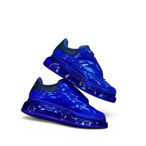 Bright blue sneakers with shiny material and thick translucent soles.