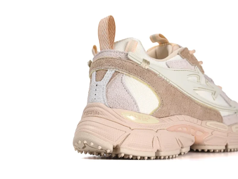 Lateral heel view highlighting the multi-layered suede and mesh panels in caramel and nude tones.