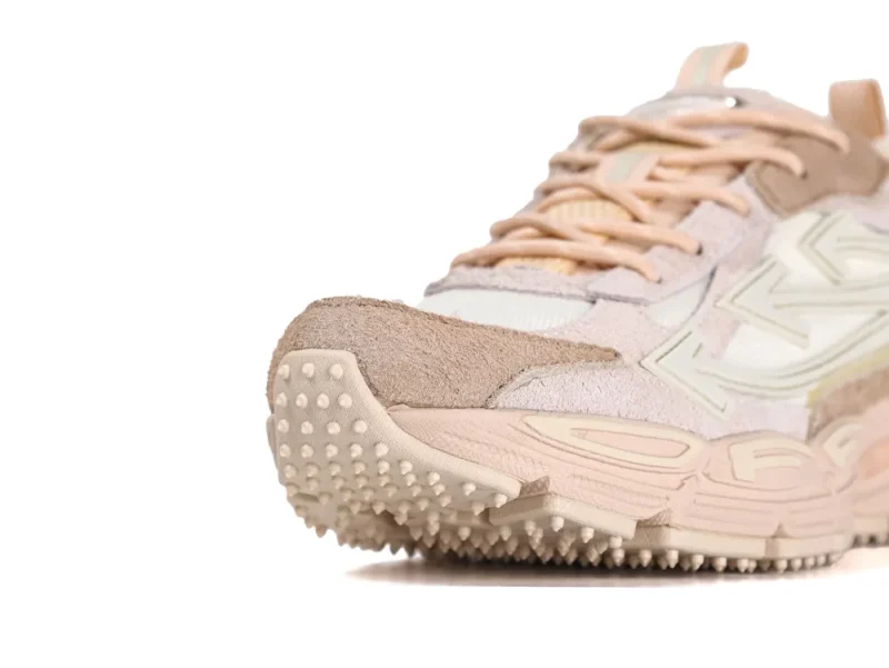 Close-up of the beige mesh toe box and spiked rubber outsole on Off-White Be Right Back sneakers.