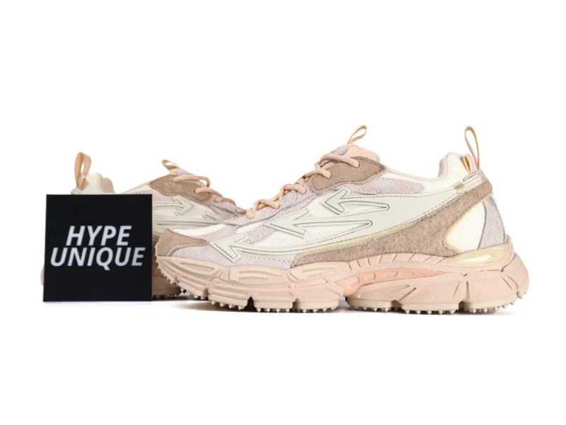 Lateral view of the Caramel Nude sneakers showcasing the signature oversized arrow logo and chunky spiked midsole.