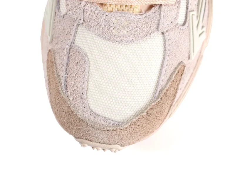 Overhead shot of the rounded beige mesh toe box surrounded by tan suede overlays.