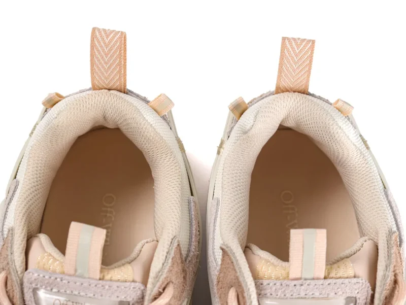 Top-down view into the padded ankle collar of the sneakers featuring striped pull tabs.