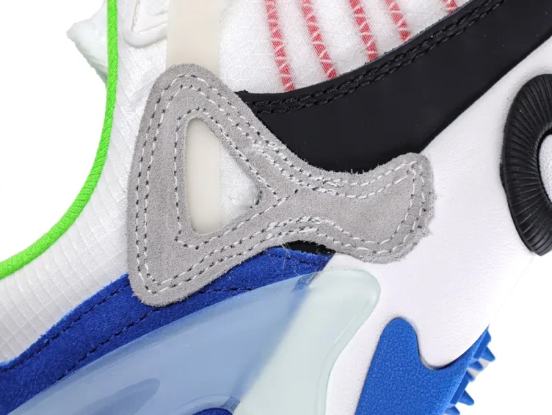 Close-up of multicolored sneaker with suede detailing and mesh fabric accents.