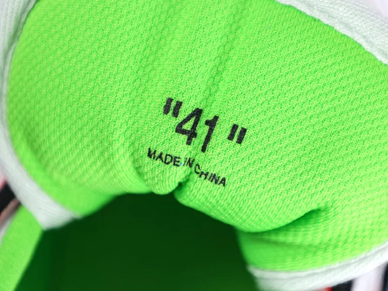 Bright green fabric sneaker interior with size "41" printed in black text.