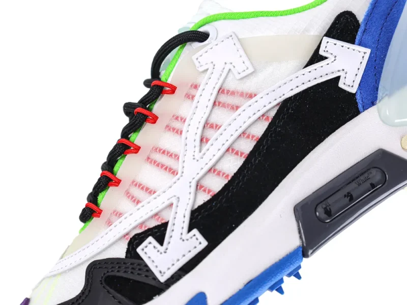 Close-up of a sneaker with colorful laces, mixed materials, and prominent arrow design.