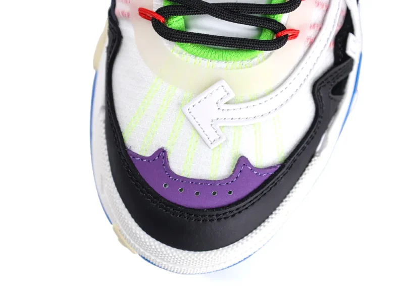 Colorful sneaker toe cap featuring black, white, and purple leather with bold stitching.