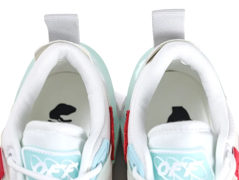 Interior view of sneakers showing Off-White branding and blue tongue labels