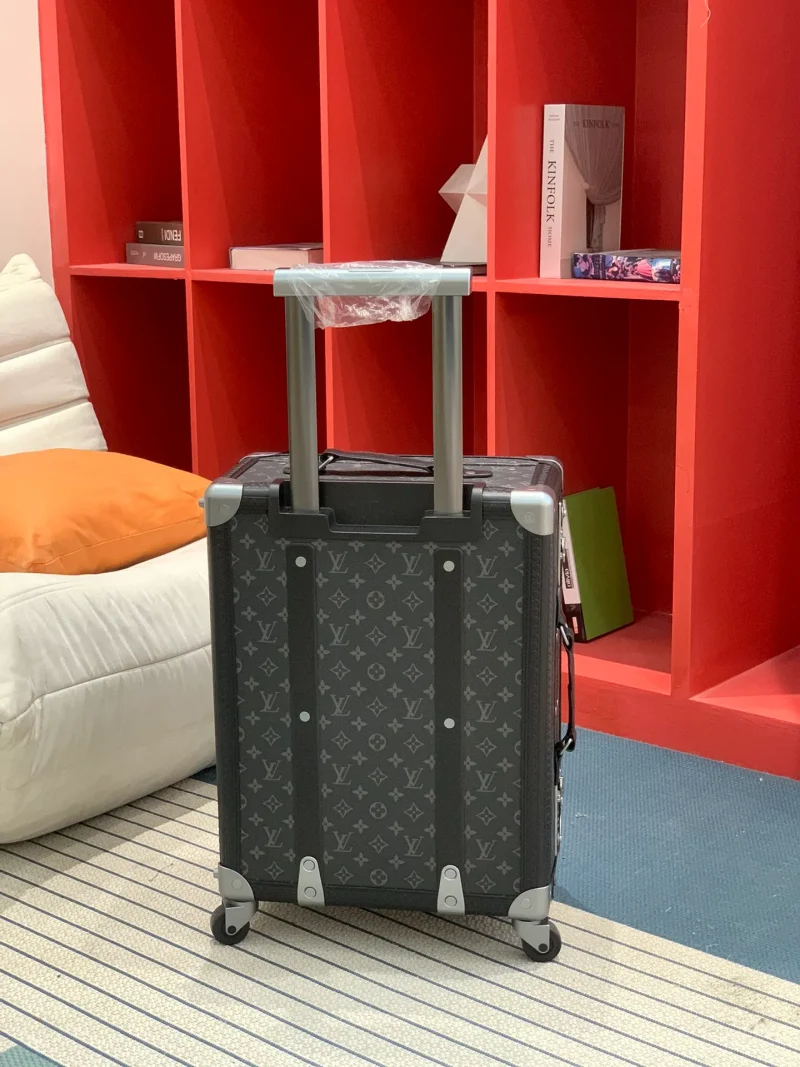 Black monogram rolling trunk rear view with extended handle